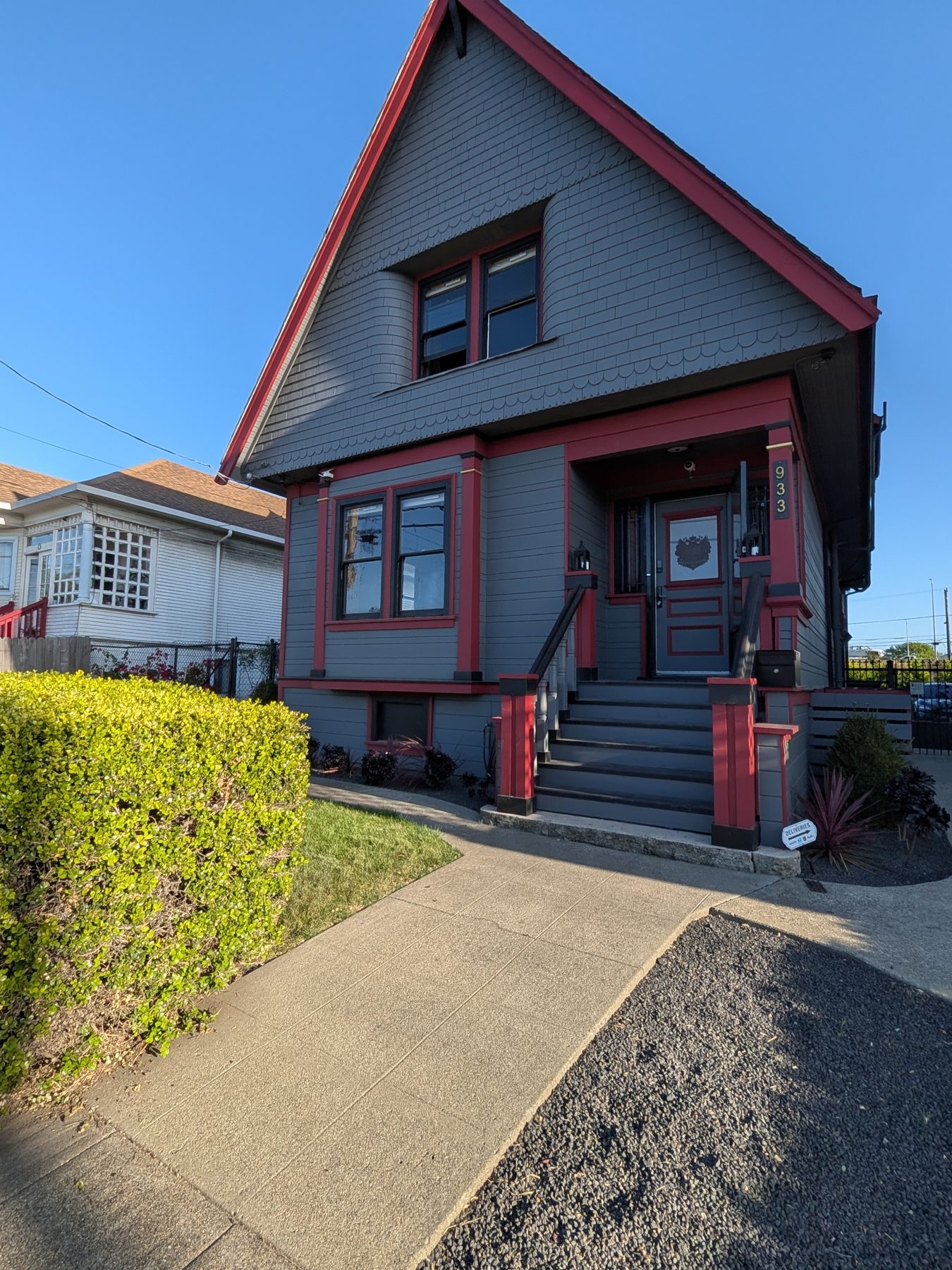 Victorian exterior with burgundy trim and landscaped front