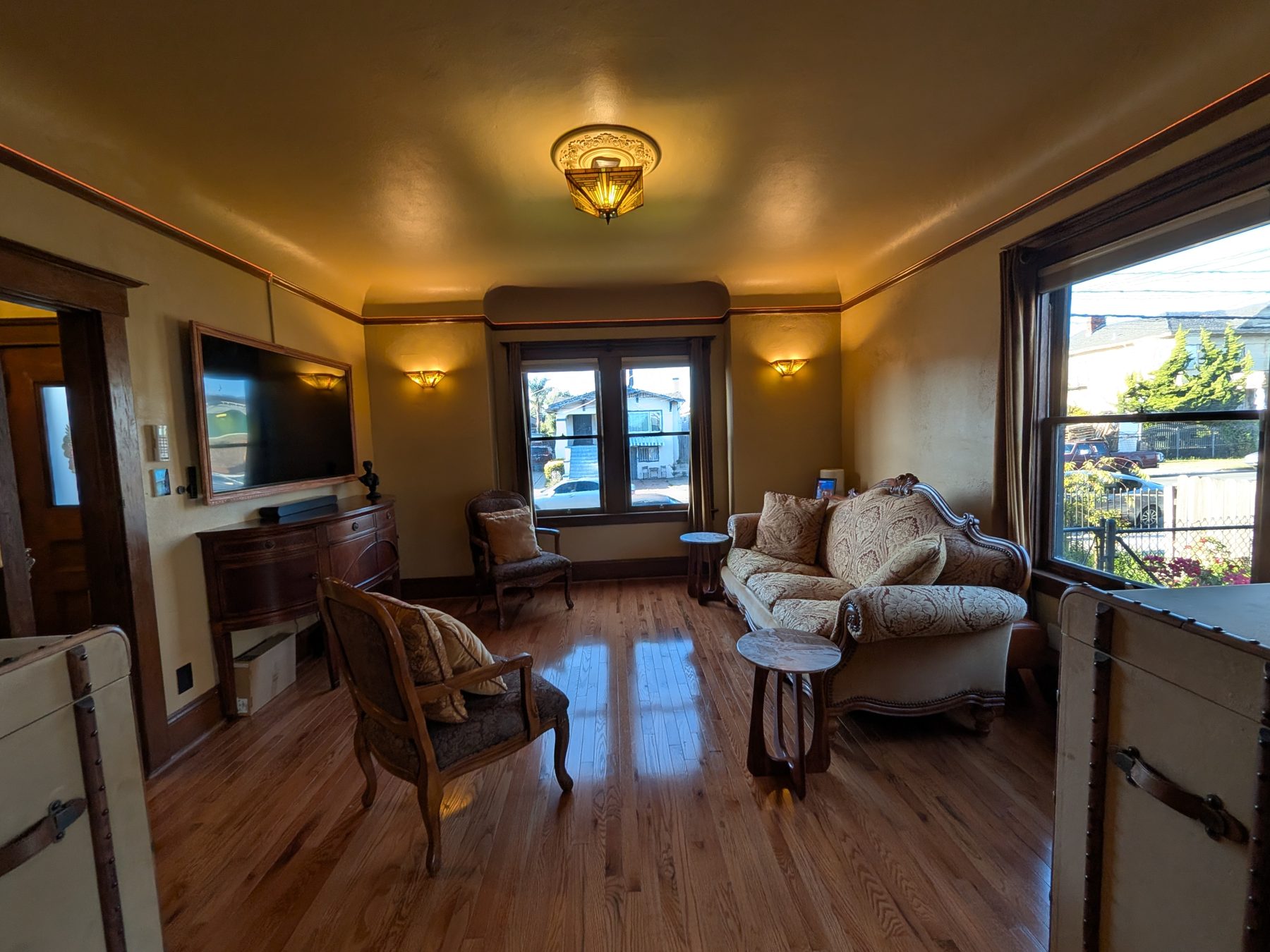 Formal living room with bay windows and period light fixtures