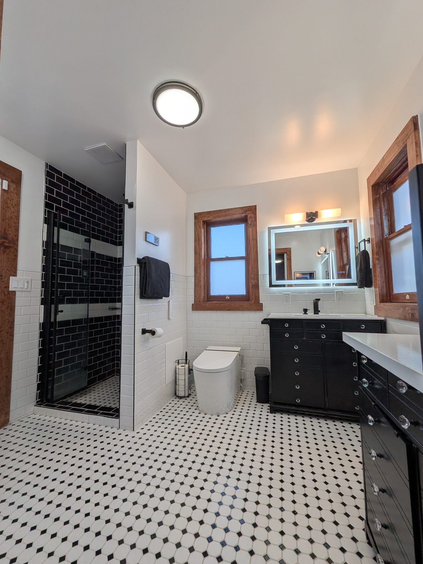 Bathroom with black vanity and classic tile
