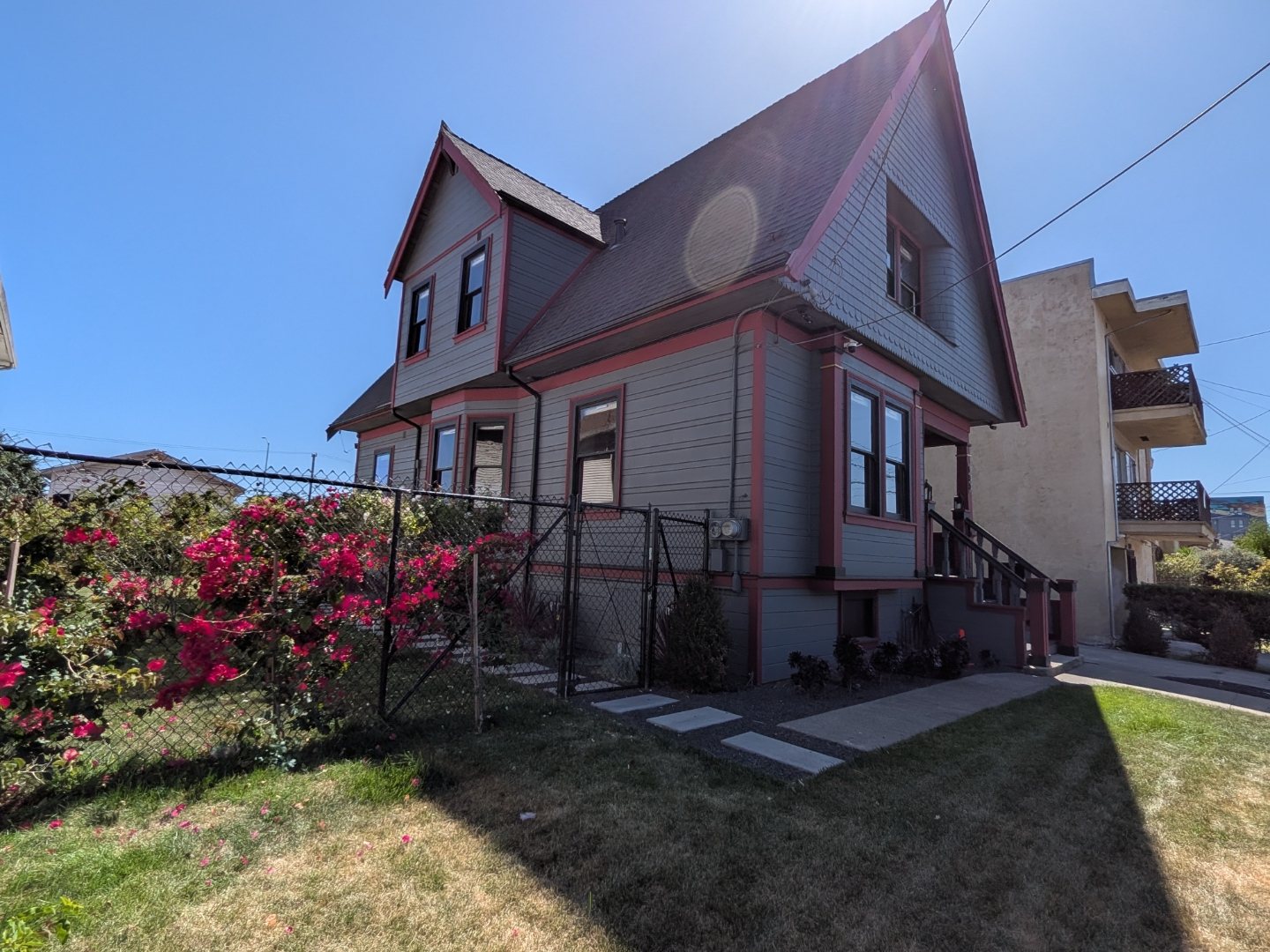 Victorian exterior facade framed by blooming rose bushes