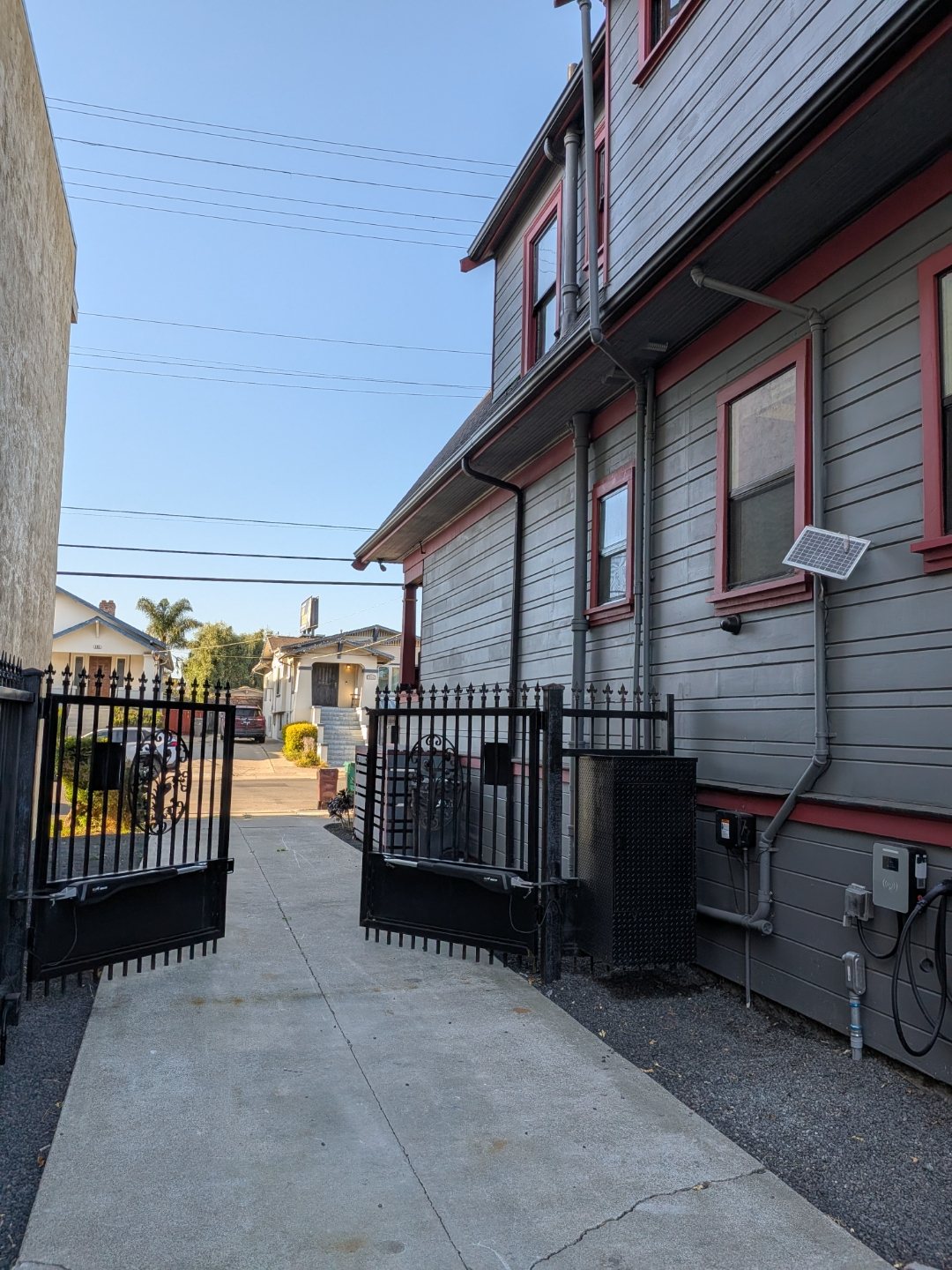 Gated side-yard walkway and entrance along the Victorian's exterior